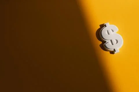 Plaster figure of dollar on a colored background Stock Photos