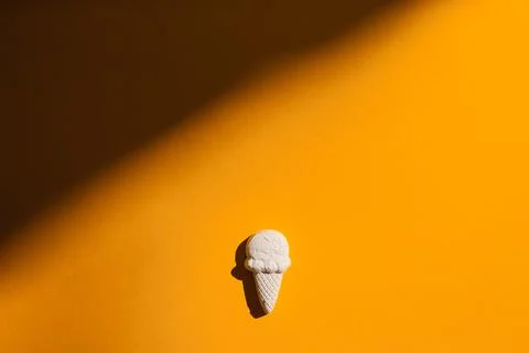 Plaster figure of ice cream on a yellow background Stock Photos