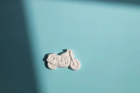 Plaster figure of motorcycle on a colored background Stock Photos