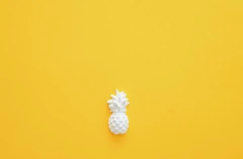 A plaster figure of a pineapple on a colored background Stock Photos