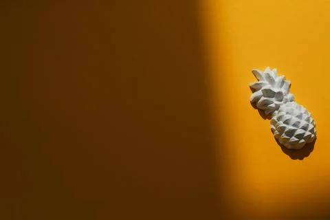 A plaster figure of a pineapple on a colored background Stock Photos