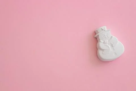Plaster figure of a snowman on a colored background Stock Photos