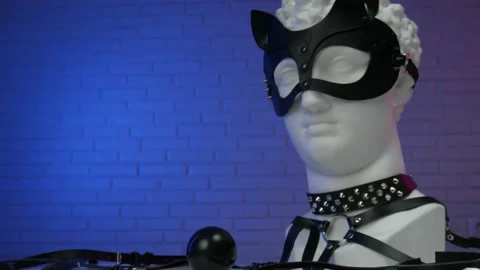 Plaster head of David in accessories BDSM mask whip leather collar and belt Stock Footage 146265517