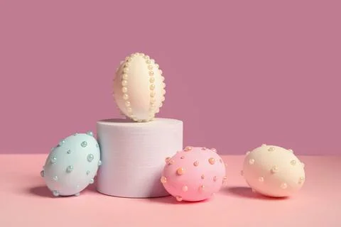 Plaster podium and Easter eggs decorated with pearls on color background Stock Photos
