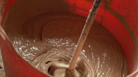 Plaster powder poured and mixed by electric paddle mixer denoise Video stock 82010761