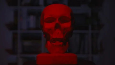 Plaster skull model for artists. Red color floats across the skull. Front face Stock Footage 124952240