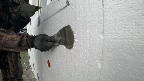 Plaster the wall with cement. Thermal insulation of house foam.  Close-up. Stock Footage 94197468