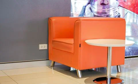 Plaster wall chairs in the empty room and tables on the sides serve as backgr Stock Photos
