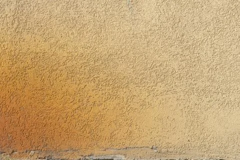 Plaster wall, chipped paint, yellow texture, background Stock Photos