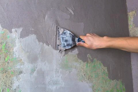 Plaster the wall with a putty knife.Internal construction and finishing works Stock Photos