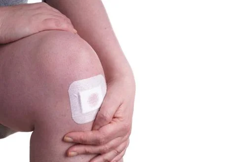 Plaster on a Womans Knee Stock Photos