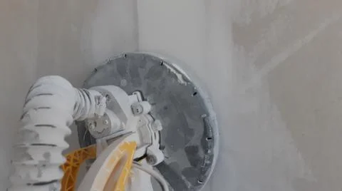 Plasterboard circular sander during DIY renovation works in residential room  Stock Photos