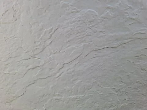 Plastered cream wall texture showcasing subtle patterns and variations in s.. Stock Photos