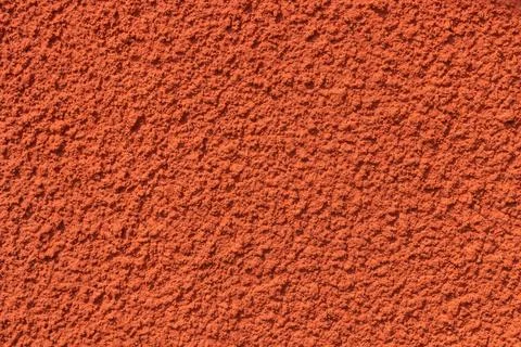 Plastered red wall with rough texture, uneven surface highlight rustic Nordic Foto stock