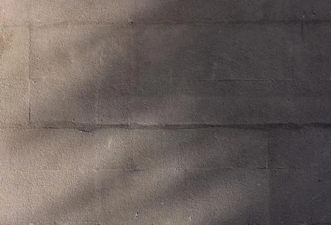 Plastered wall with sun rays as background Foto stock