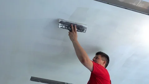 Plasterer apply plaster with trowel on ceiling Stock Footage 107407226