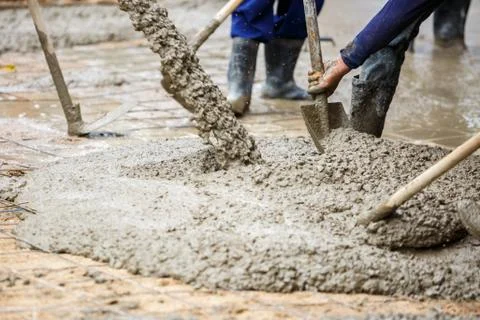 Plasterer concrete worker at floor construction Stock Photos