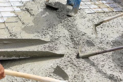 A plasterer concrete worker at floor work Stock Photos