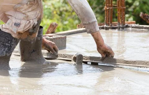 Plasterer concrete worker at floor work Stock Photos