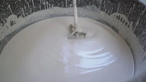 Plasterer knead the solution with a perforator. Workers knead a white solutio Stock Photos