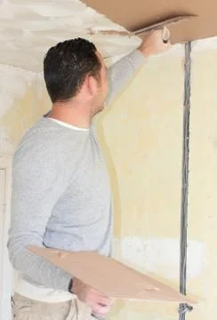 A plasterer plastering a ceiling Stock Photos