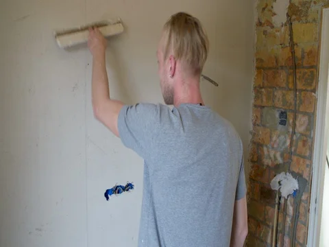 Plasterer plastering a wall  in a renovation bathroom house, medium shot Stock Footage 75671265