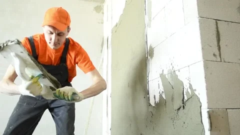 Plasterer putting plaster on wall. slow motion Video stock 88042797
