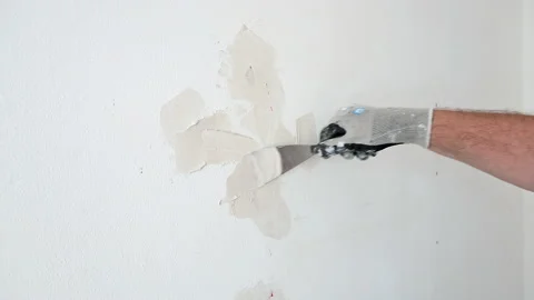 Plasterer puttying holes in the wall Stock Footage 194347915