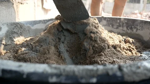 Plasterer use a hoe to mixed cement and sand in the pickup at construction site. Stock Footage 128630547