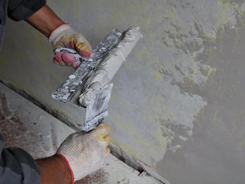 Plasterer work with two spatulas and mortar Stock Photos
