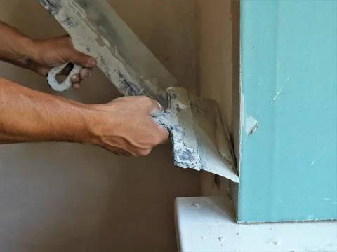 Plasterer work with window slope and putty Stock Photos