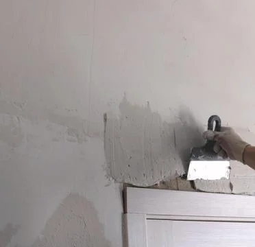 Plastering of cracks in the door frame with space for text Stock Photos