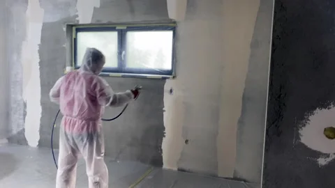 Plastering the interior of a new house using a machine Stock Footage 233968861