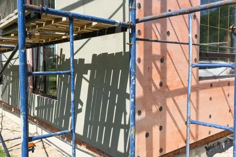 Plastering over insulation on facade, external wall rendering, scaffolding .. 스톡 사진