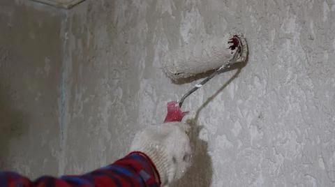 Plastering a room wall with a roller Stock Photos