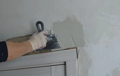 Plastering slopes after installing a room door Stock Photos