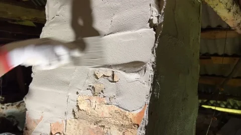 Plastering a stove pipe in a rustic house. Video stock 235219117