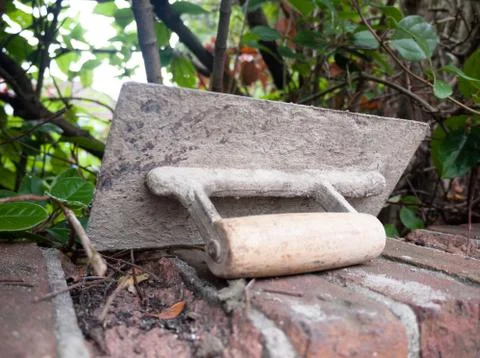 A plastering tool flat trowel resting on a wall Stock Photos
