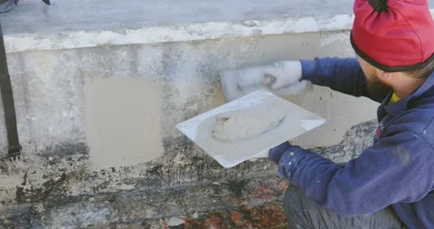 Plastering tool plaster marble on plaster rough, selective focus. 스톡 동영상 168802313