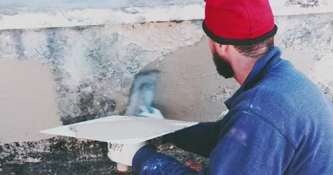 Plastering tool plaster marble on plaster rough, selective focus. 스톡 동영상 168802380