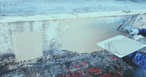 Plastering tool plaster marble on plaster rough, selective focus. Vídeo Stock 196940606