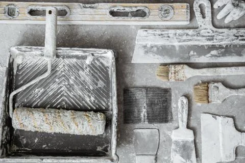 Plastering tools on cement background. Stock Photos