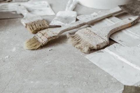Plastering tools on cement background. Photos