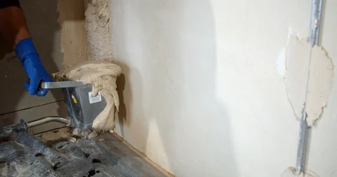Plastering the walls with the plaster hopper bucket, tools of construction, 4k Stock Footage 129321649