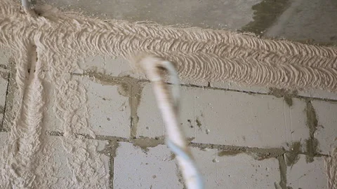 Plastering Walls with a plasterer pump Machine. Close-up Stock Footage 102166657
