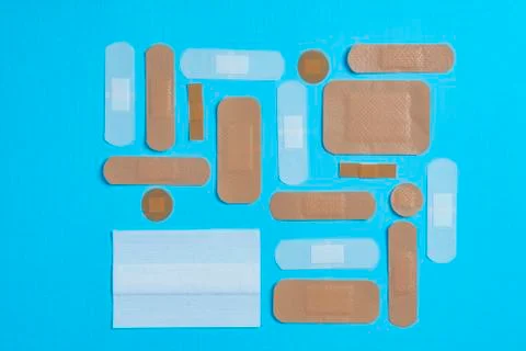 Plasters on a blue surface Stock Photos