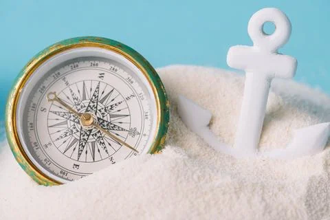 Plastic anchor compass white sand Stock Photos