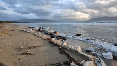 Plastic and garbage on a beach during sunset Stock Footage 169883494
