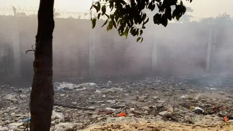 Plastic and garbage burning causing severe local air pollution alongside brick Stock Footage 345626923