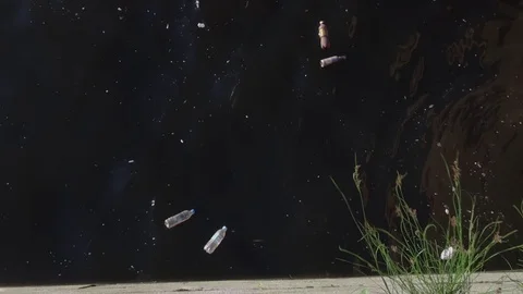 Plastic and glass bottles trash in water pollute the environment of the river Stock Footage 122015798